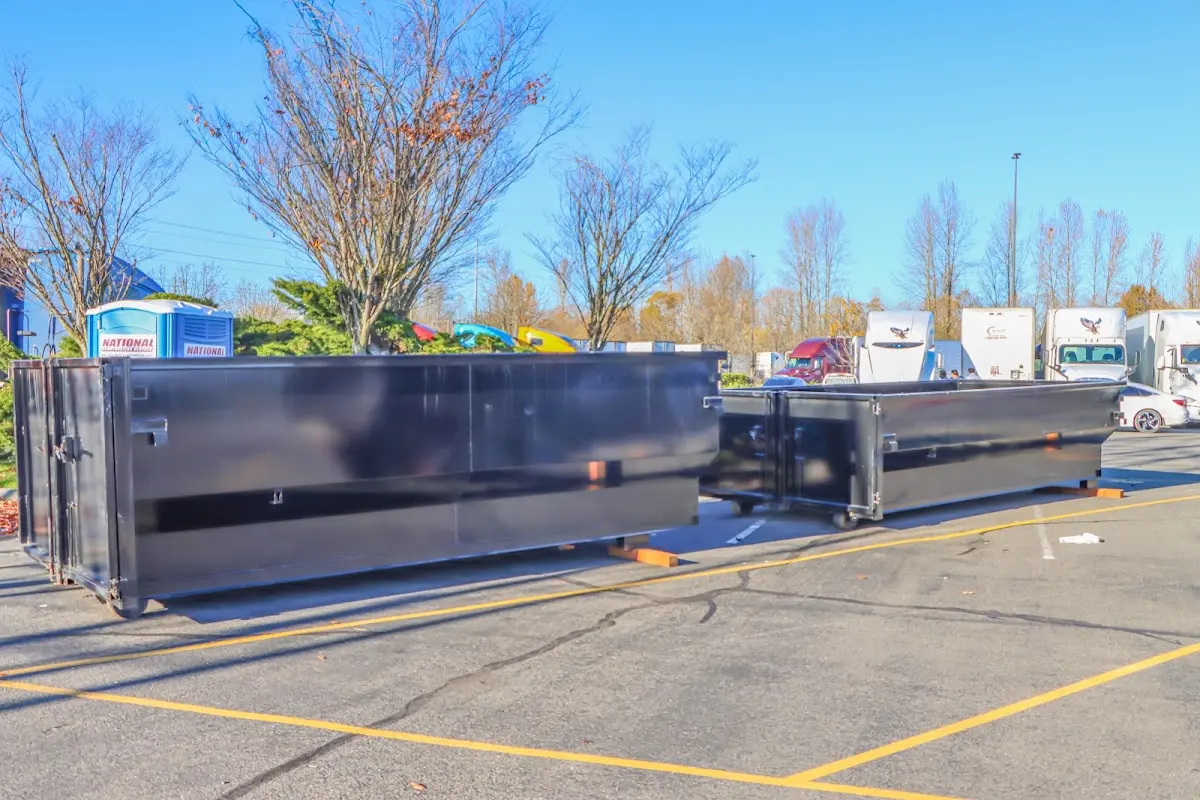 Professional dumpster rental service with roll-off container on residential driveway in Aurora